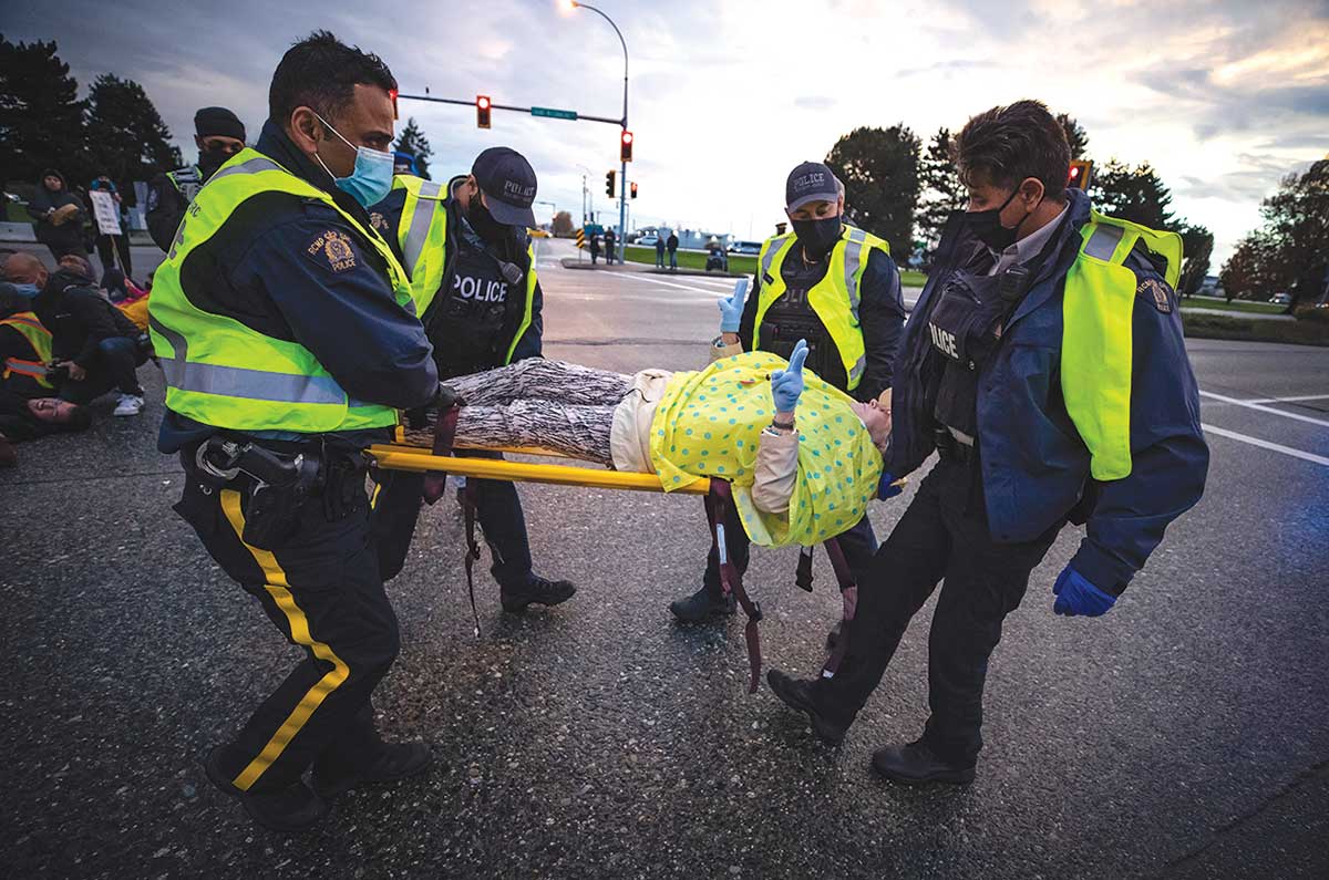 A protester is arrested during the October 2021 action that Haq participated in.