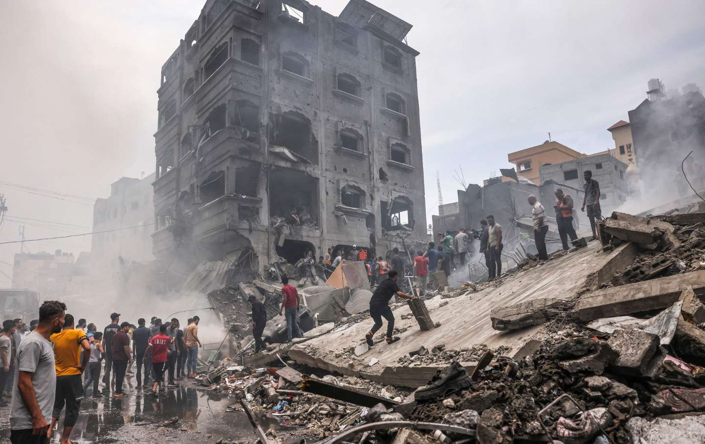 Palestinians search for survivors after an Israeli airstrike on buildings in the refugee camp of Jabalia in the Gaza Strip on October 9, 2023.