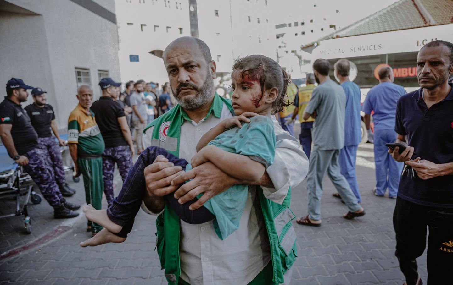 A man cradles a child injured during the bombing of the Gaza Strip.
