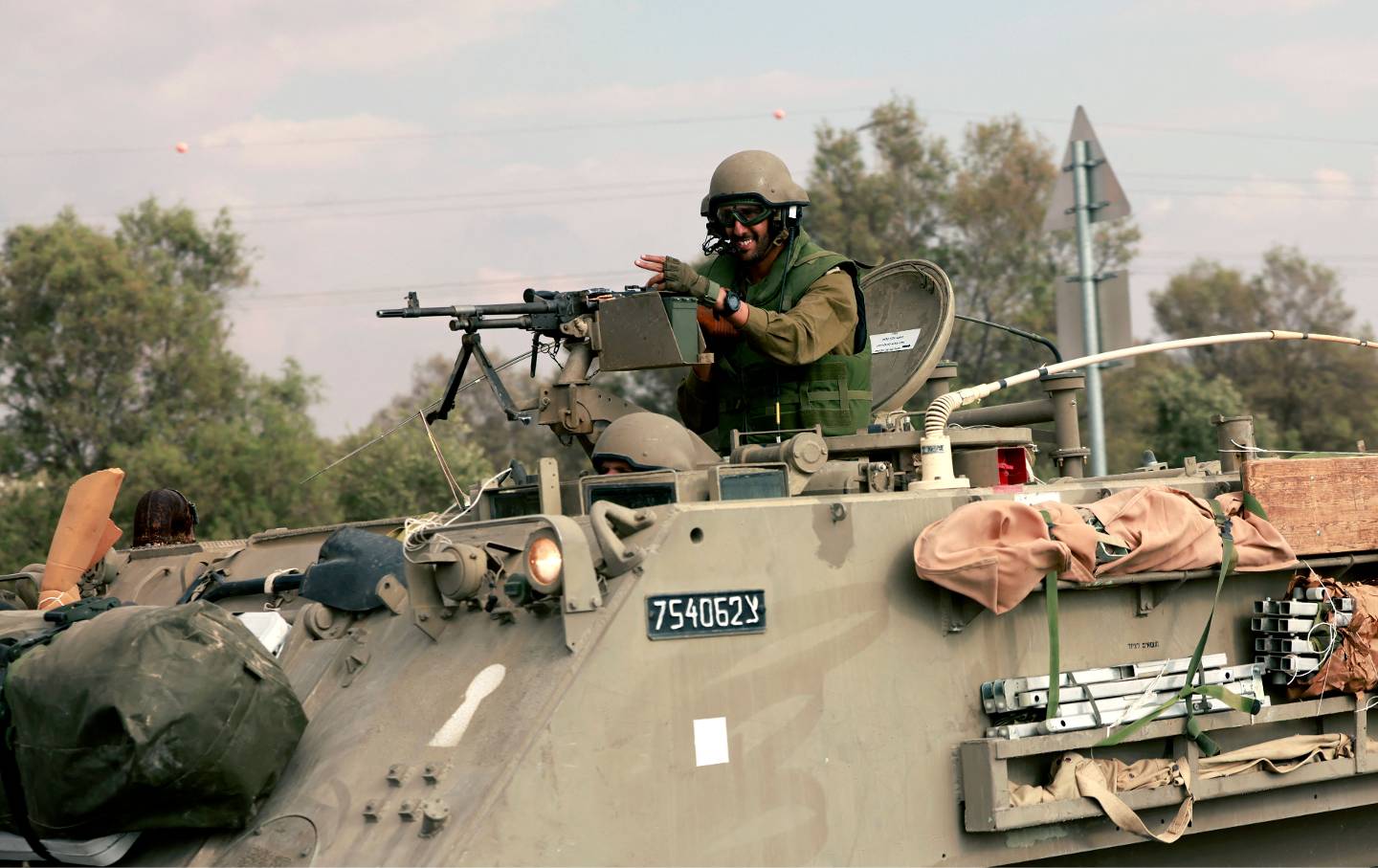 An Israeli solider rides toward the border with the Gaza Strip on October 16, 2023.