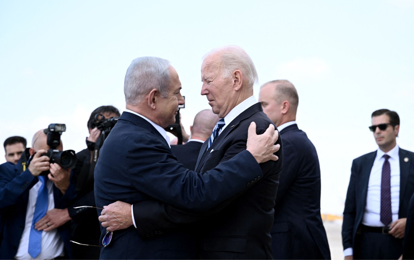 Israel Prime Minister Benjamin Netanyahu (L) greets US President Joe Biden upon his arrival at Tel Aviv's Ben Gurion airport on October 18, 2023
