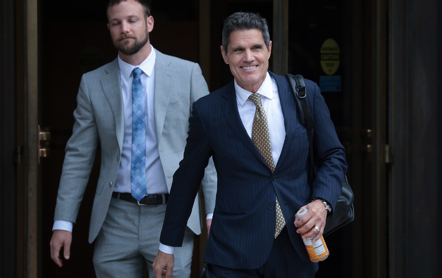 Attorney for former US president Donald Trump John Lauro (R) departs the E. Barrett Prettyman US Court House, October 16, 2023, in Washington, D.C.