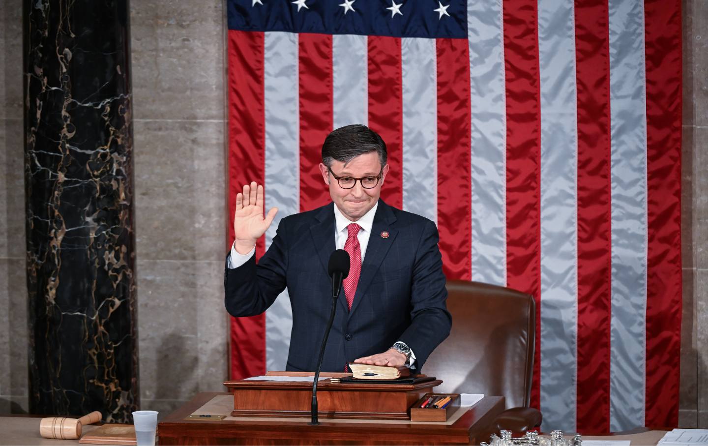 Speaker of the House Mike Johnson (R-LA) takes the oath in the House chambers as members of the House of Representatives