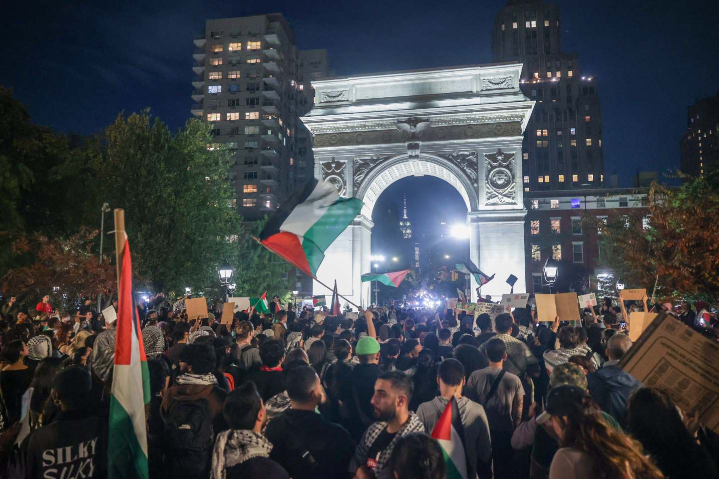 Pro-Palestinian demonstrators march with banners from Wall Street to Washington Square Park.