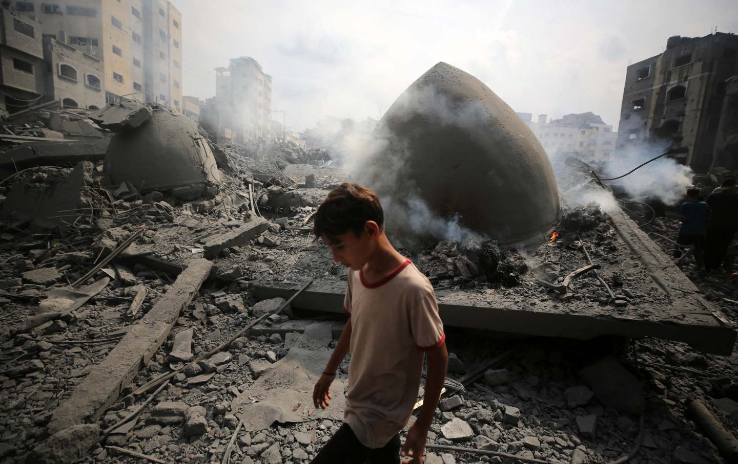 Palestinians inspect the damage following an Israeli air strike on the Sousi mosque in Gaza City on October 9, 2023.