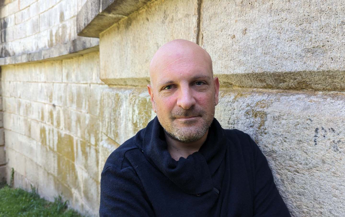 Josh Paul in front of a stone wall