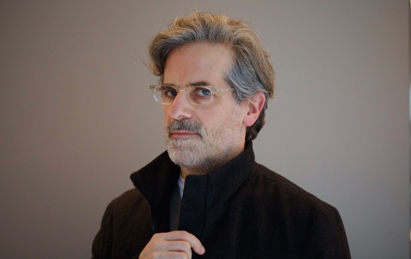 Writer Jonathan Lethem poses for a photo against a gray background