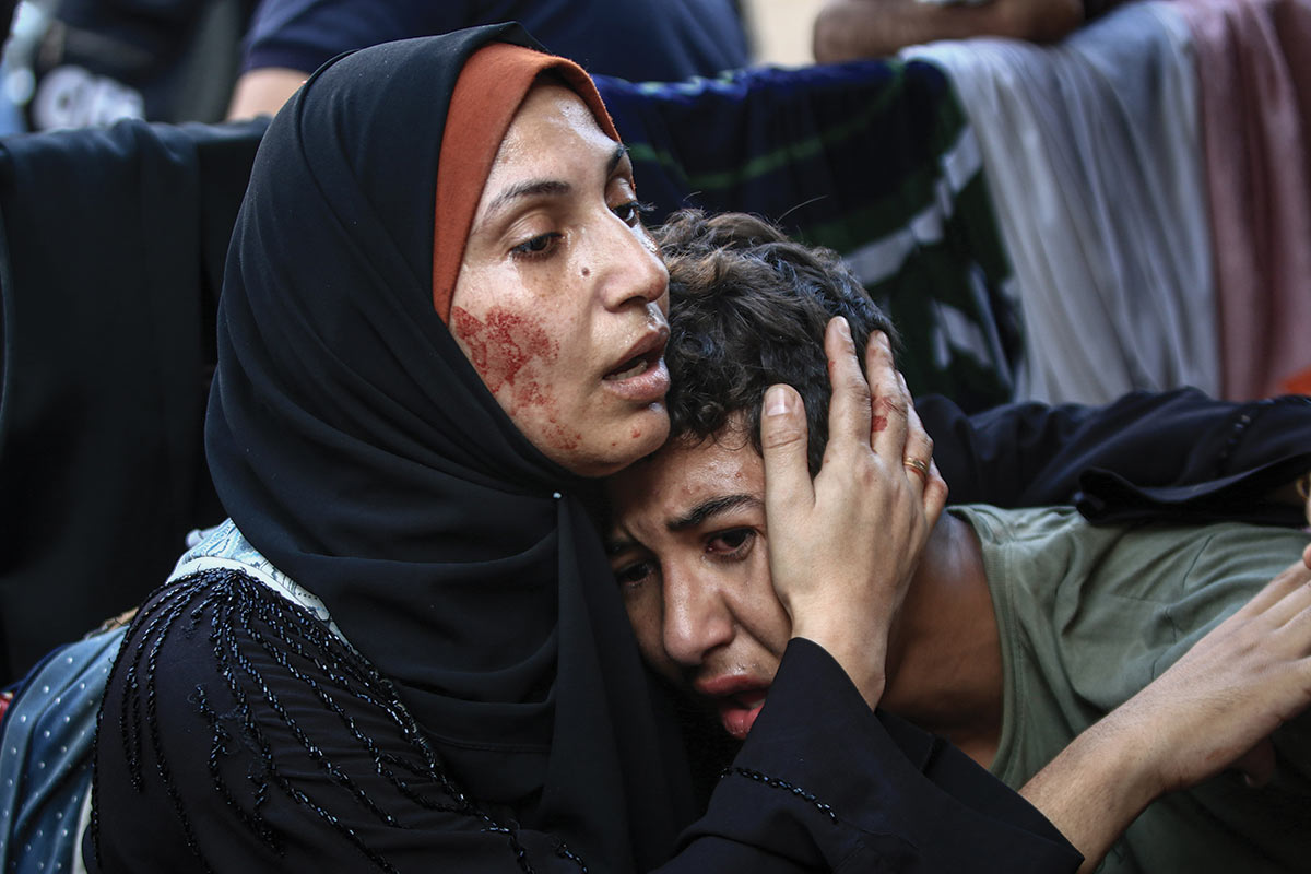 A Palestinian woman consoles a child after an Israeli strike on the al-Fakhoora district of Gaza on November 4.