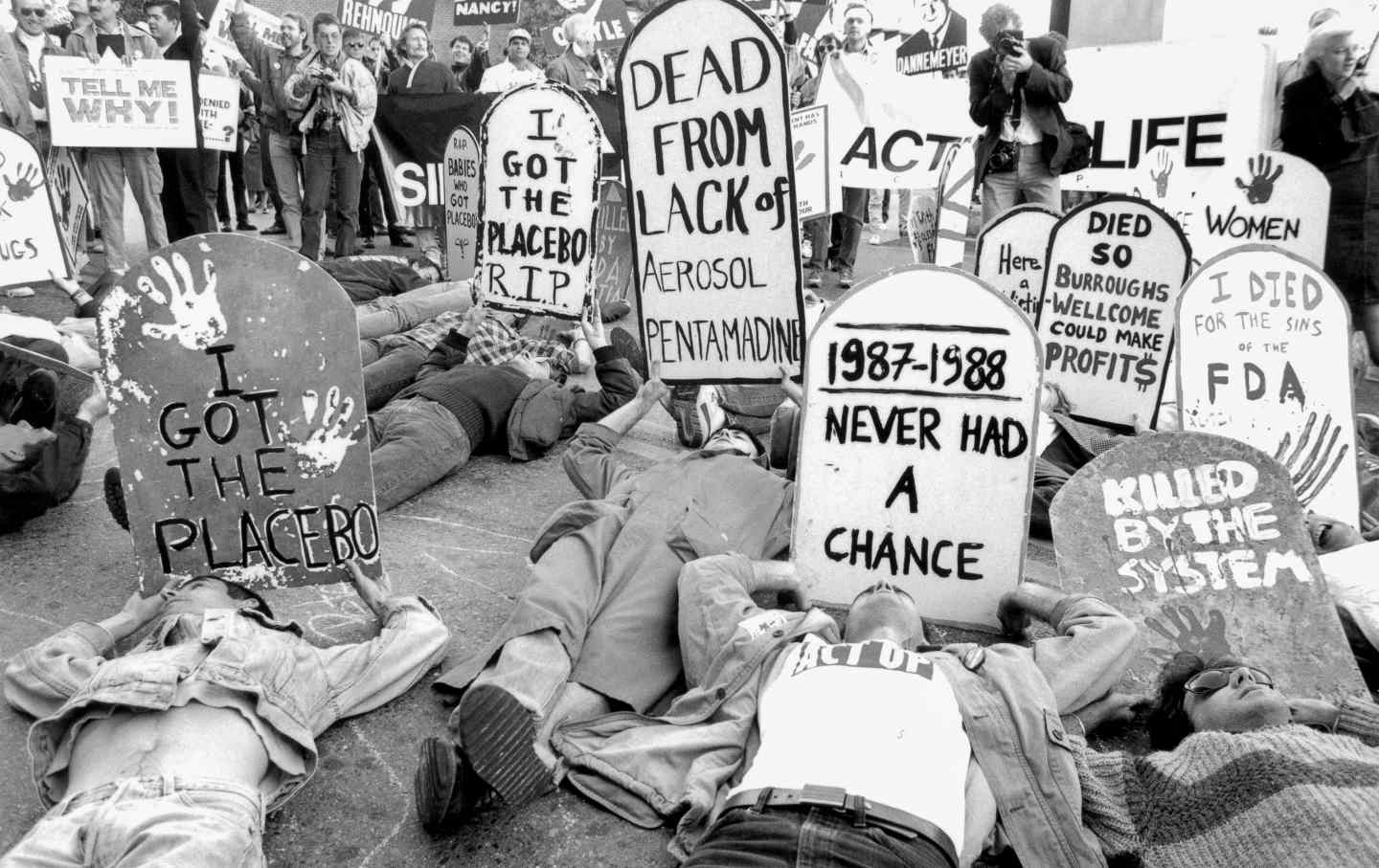 ACT UP protesters close the Federal Drug Administration building to demand the release of experimental medication for those living with HIV/AIDS. Their slogans read: “Never Had A Chance;” “Dead From Lack of Aerosol Pentamadine”; “I Got The Placebo”; “I Died for the Sins of the FDA.” The demonstration was held outside the FDA headquarters in Rockville, Md., on October 11, 1988.