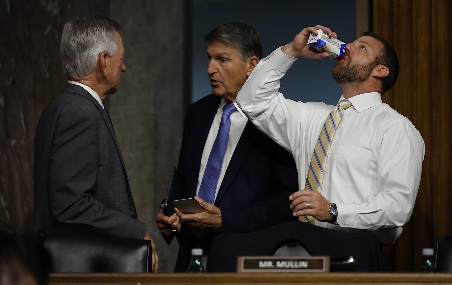 Senate Armed Services Committee members Senators Tommy Tuberville (R-Ala.), Joe Manchin (R-W.Va.), and Markwayne Mullin (R-Okla.) talk before a hearing of the National Security Agency and US Cyber Command in the Dirksen Senate Office Building on Capitol Hill in Washington, D.C.