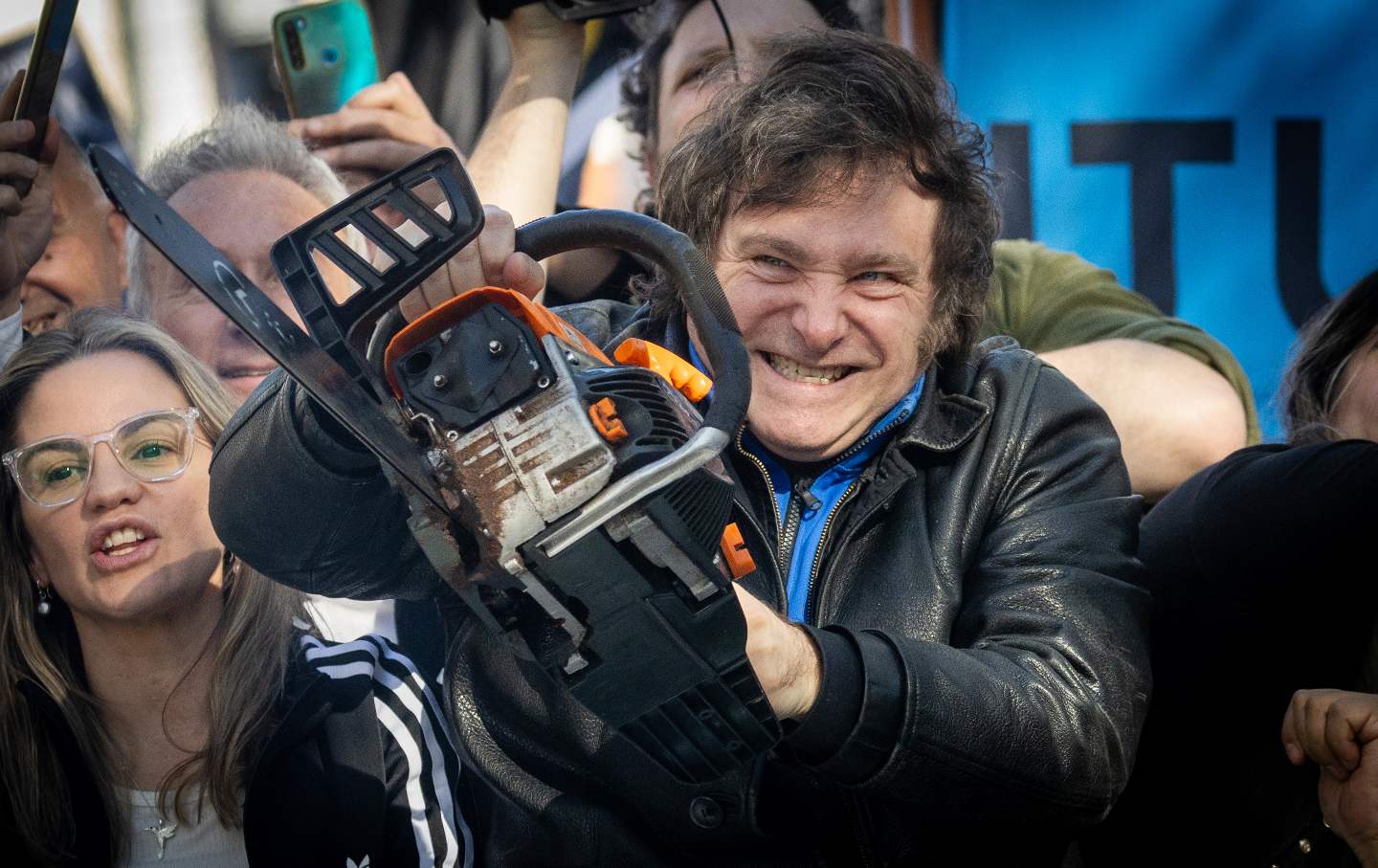 Javier Milei lifts a chain saw next to Buenos Aires province governor candidate Carolina Píparo during a rally on September 25, 2023 in San Martin, Buenos Aires, Argentina.