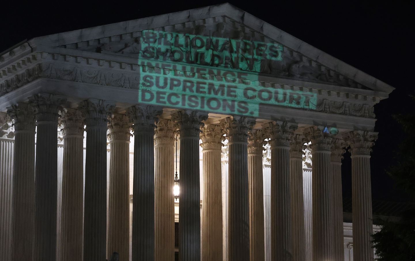 Government watchdog Accountable.US shines a light on the facade of the Supreme Court Building as part of a campaign calling attention to corruption on the court.