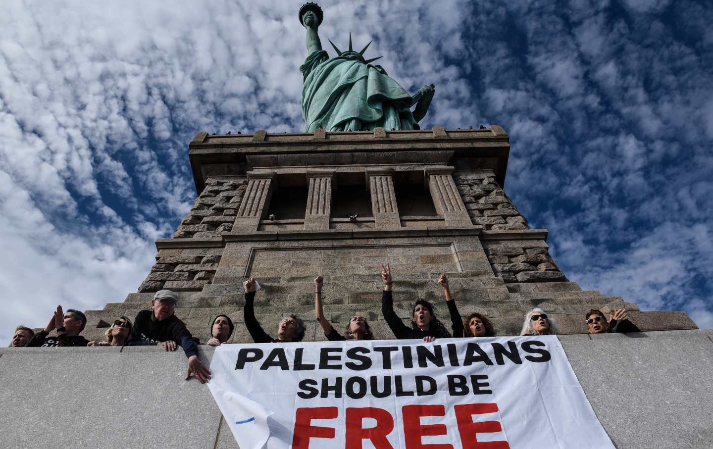 Activists from Jewish Voice for Peace occupy the pedestal of the Statue of Liberty on November 6, 2023, in New York City.