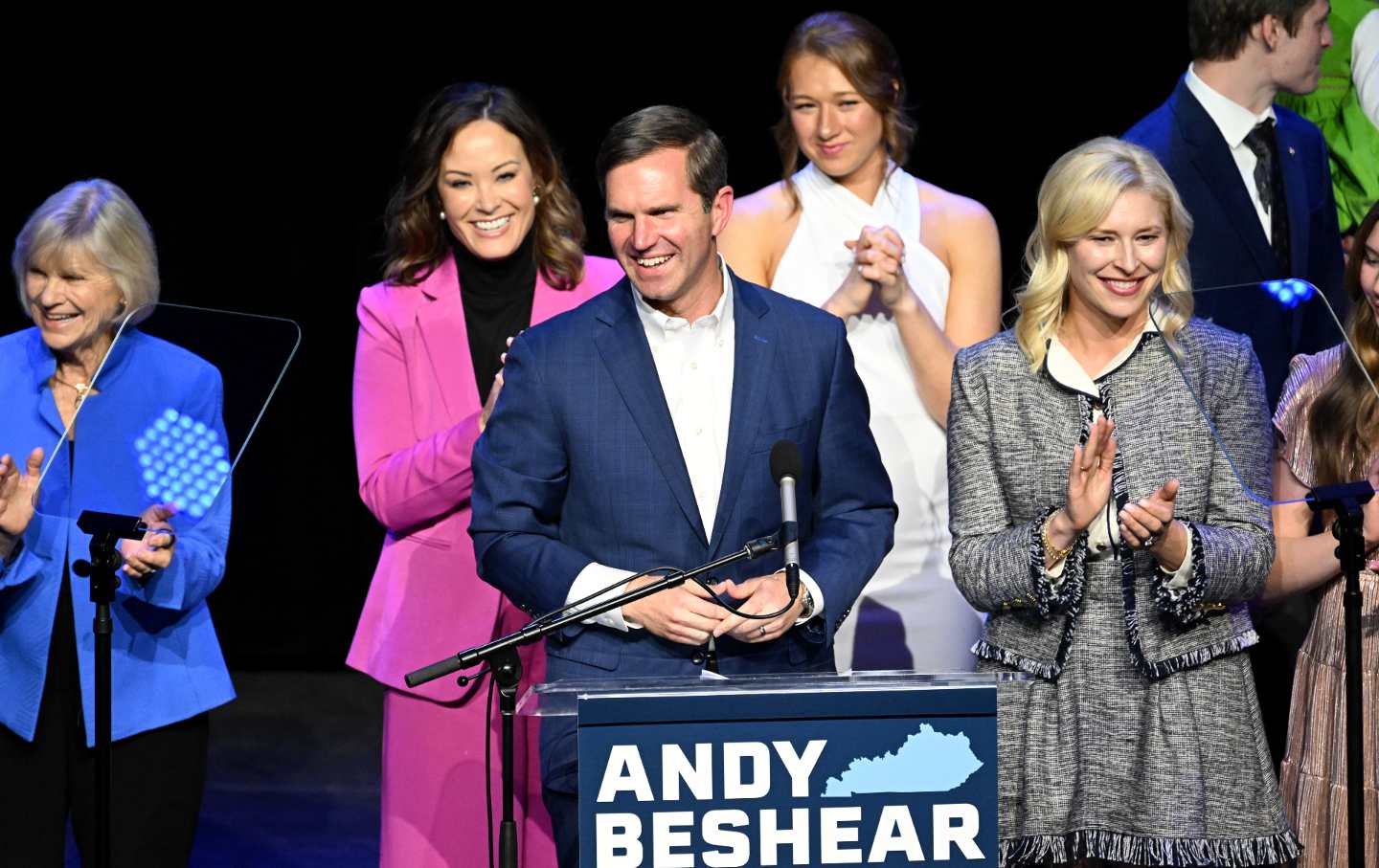 Outgoing Democratic Governor of Kentucky Andy Beshear joins his wife, Brittany Beshear (R), Kentucky Lieutenant Governor Jacqueline Coleman (CL) and her family as he celebrates his victory to the crowd at an election night event at Old Forester's Paristown Hall gave a speech.  On November 7, 2023 in Louisville, Kentucky.