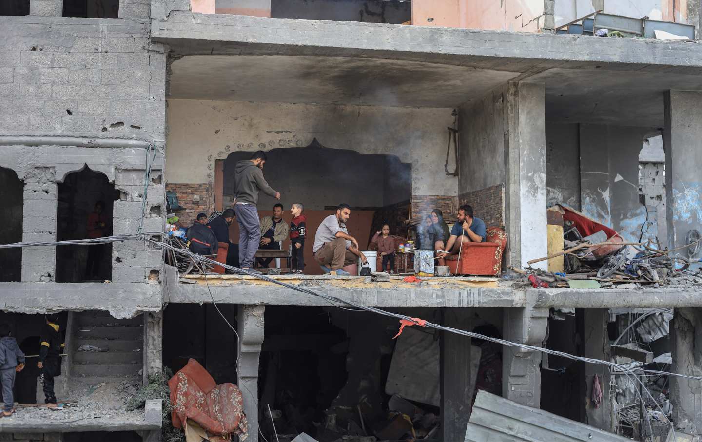 Palestinians in their destroyed home at the refugee camp in Nuseirat, Gaza, on Saturday, Nov. 25, 2023.
