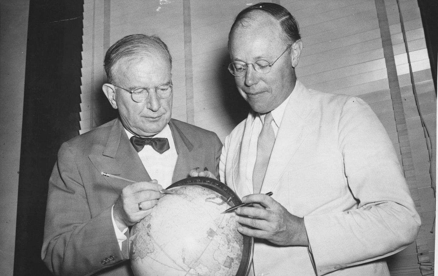 Senators Burton K. Wheeler of Montana and Robert Taft of Ohio study a globe.