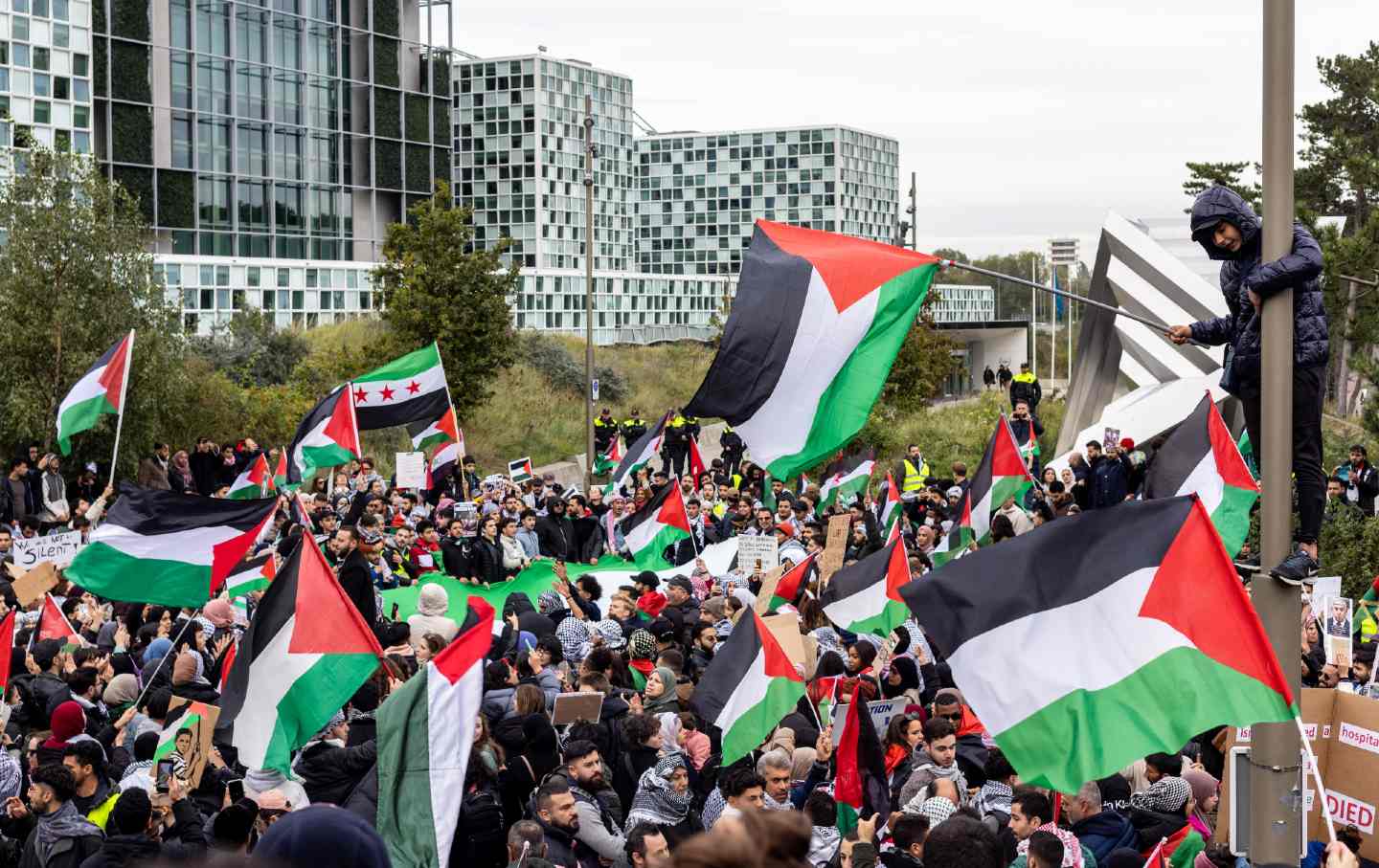 pro-Palestine protest outside International criminal court, demanding action from the ICC during ongoing bombing, genocide in Gaza