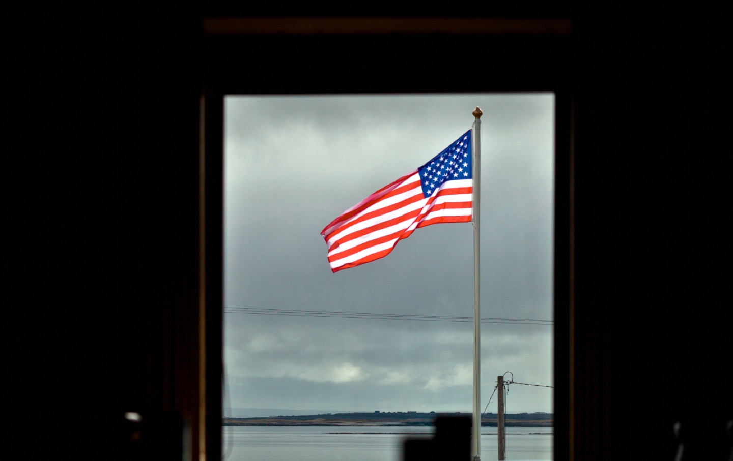 somber photo American flag, US isolationism
