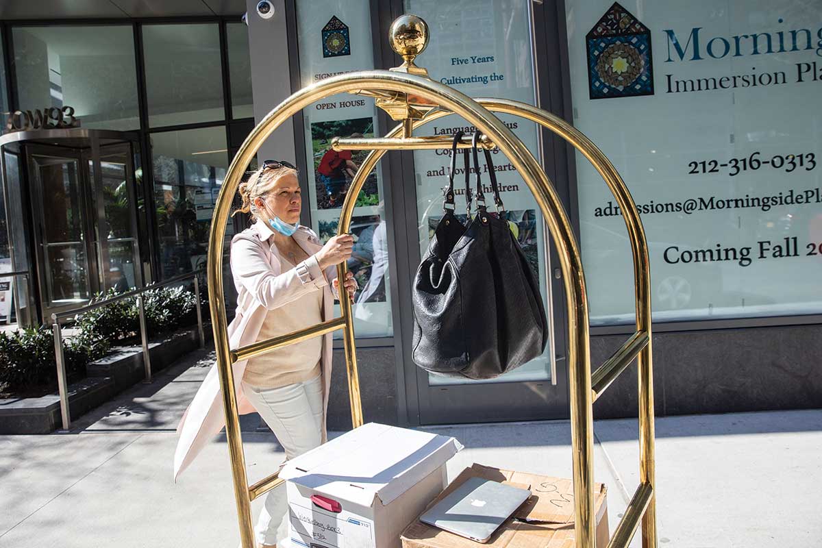 Jennifer Weisselberg outside her apartment building with documents she gave to prosecutors.