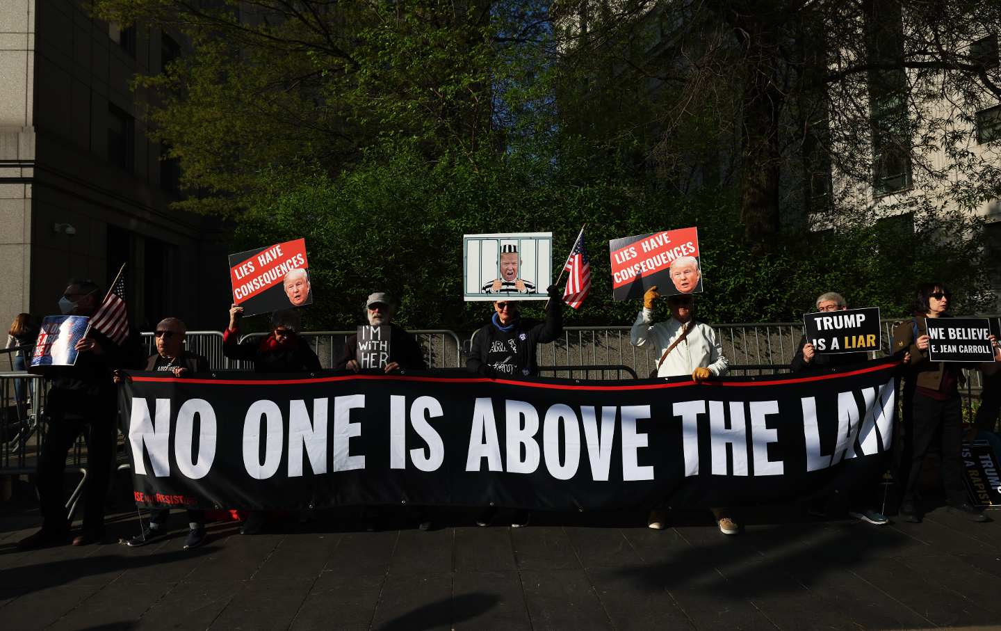 Protesters hold a banner reading 