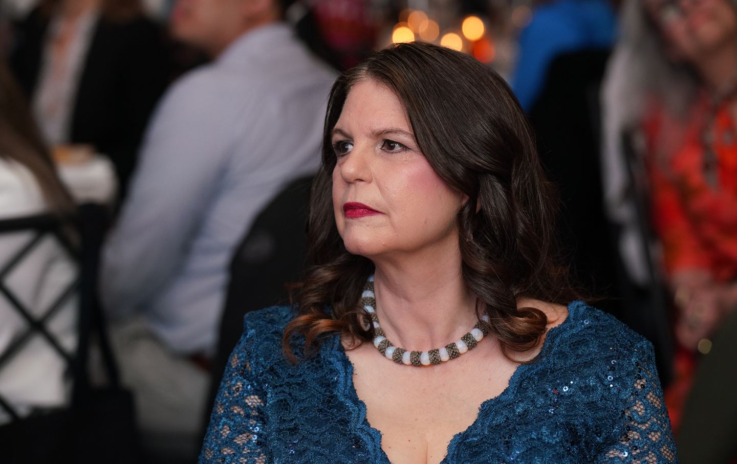 Andrea Miller seated at a gala event.