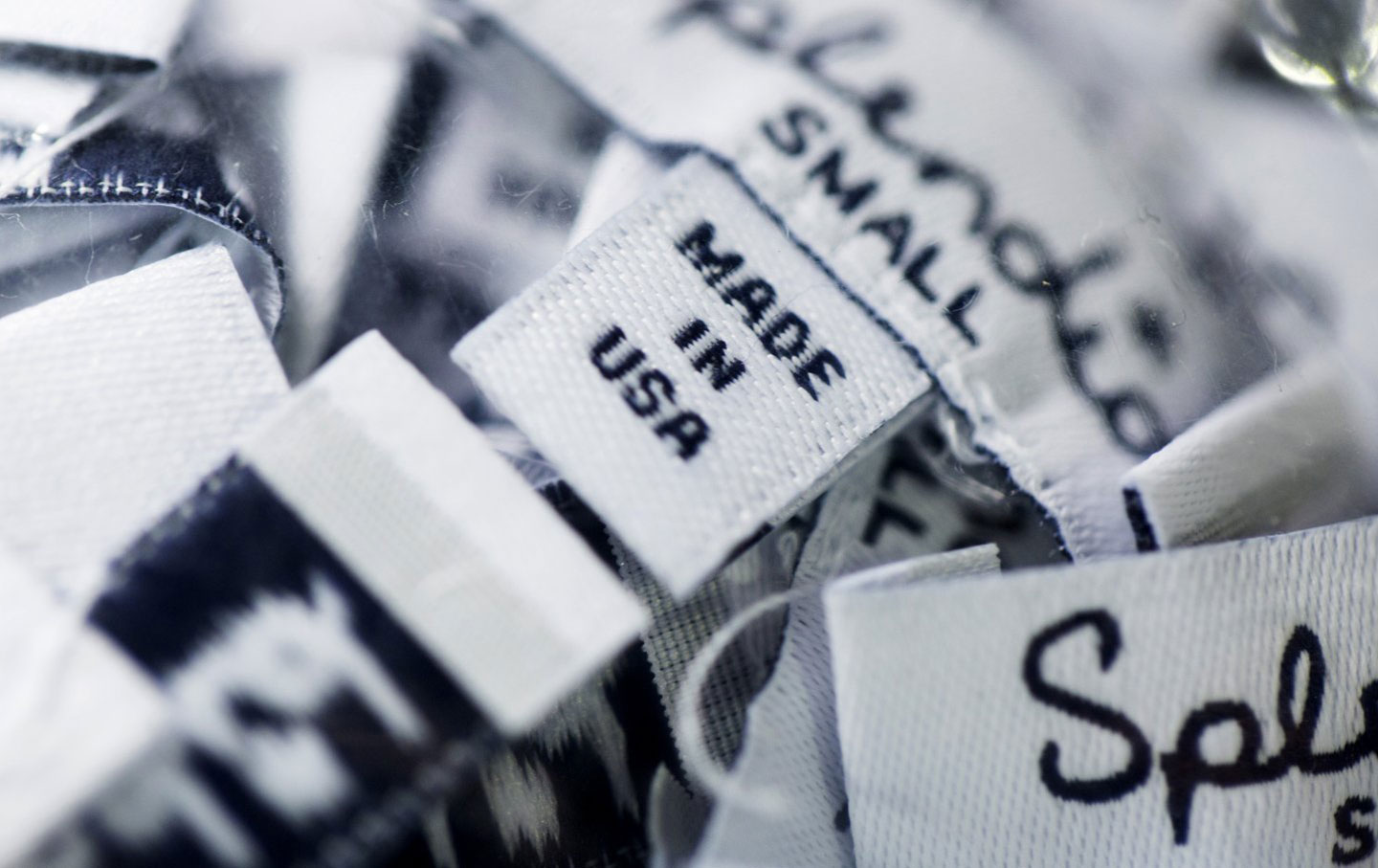 “MADE IN USA” clothing labels sit in a pile at the 5 Thread facility in Los Angeles.