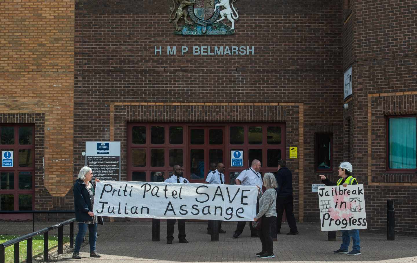 Protesters hold banners in support of Julian Assange at Belmarsh Prison on May 12, 2022, in London, England.