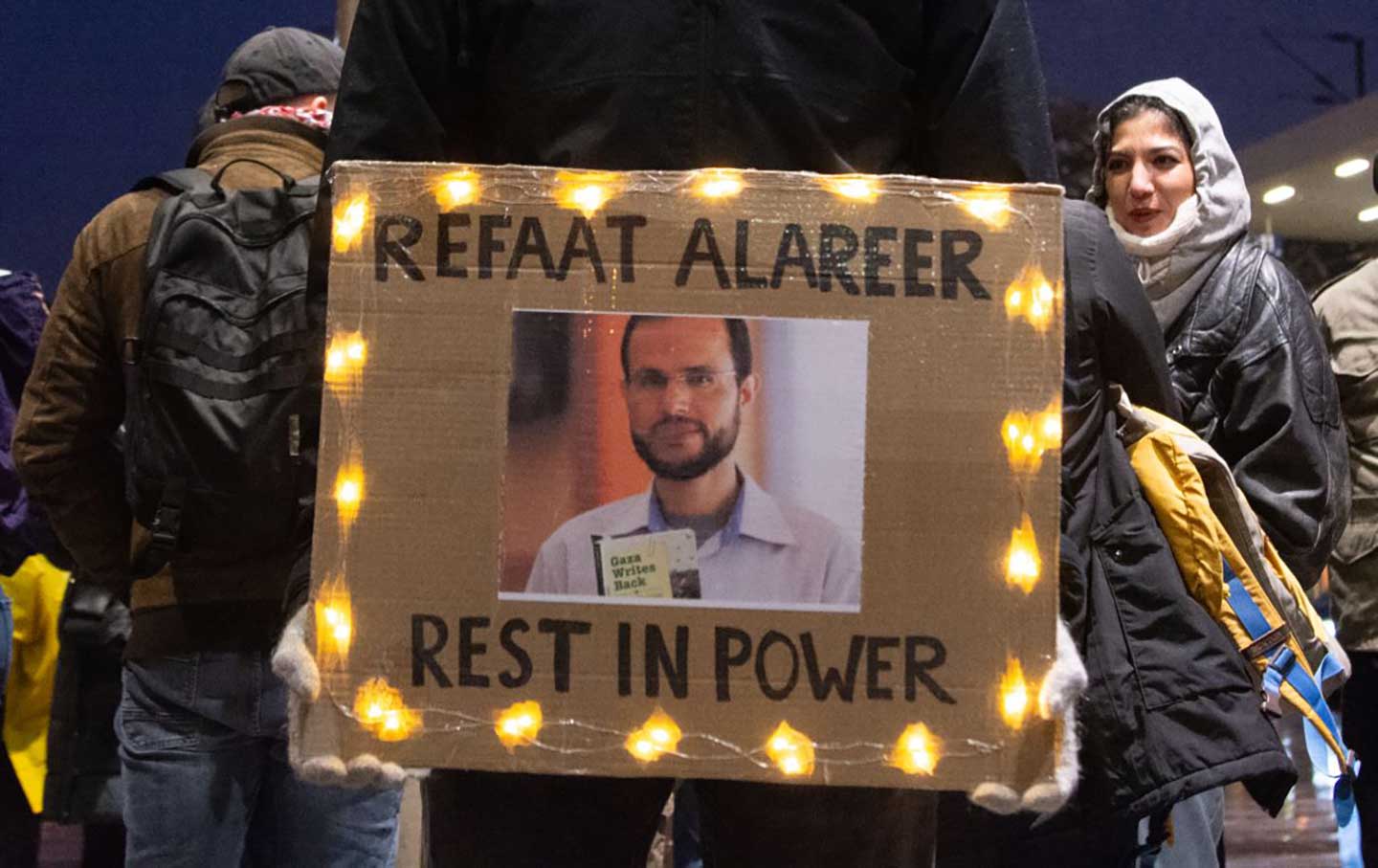 A photo of the renowned Palestinian poet Refaat Alareer is displayed at a protest calling for a cease-fire and a free Palestine in Cologne, Germany, on December 9, 2023.