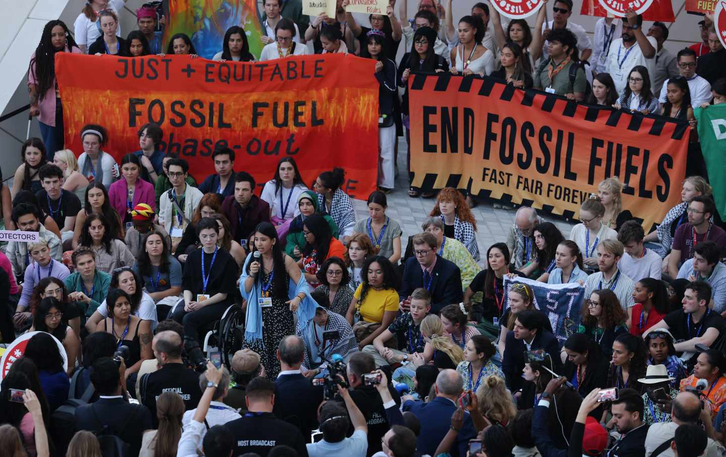 A large crowd of young climate activists, holding banners reading 