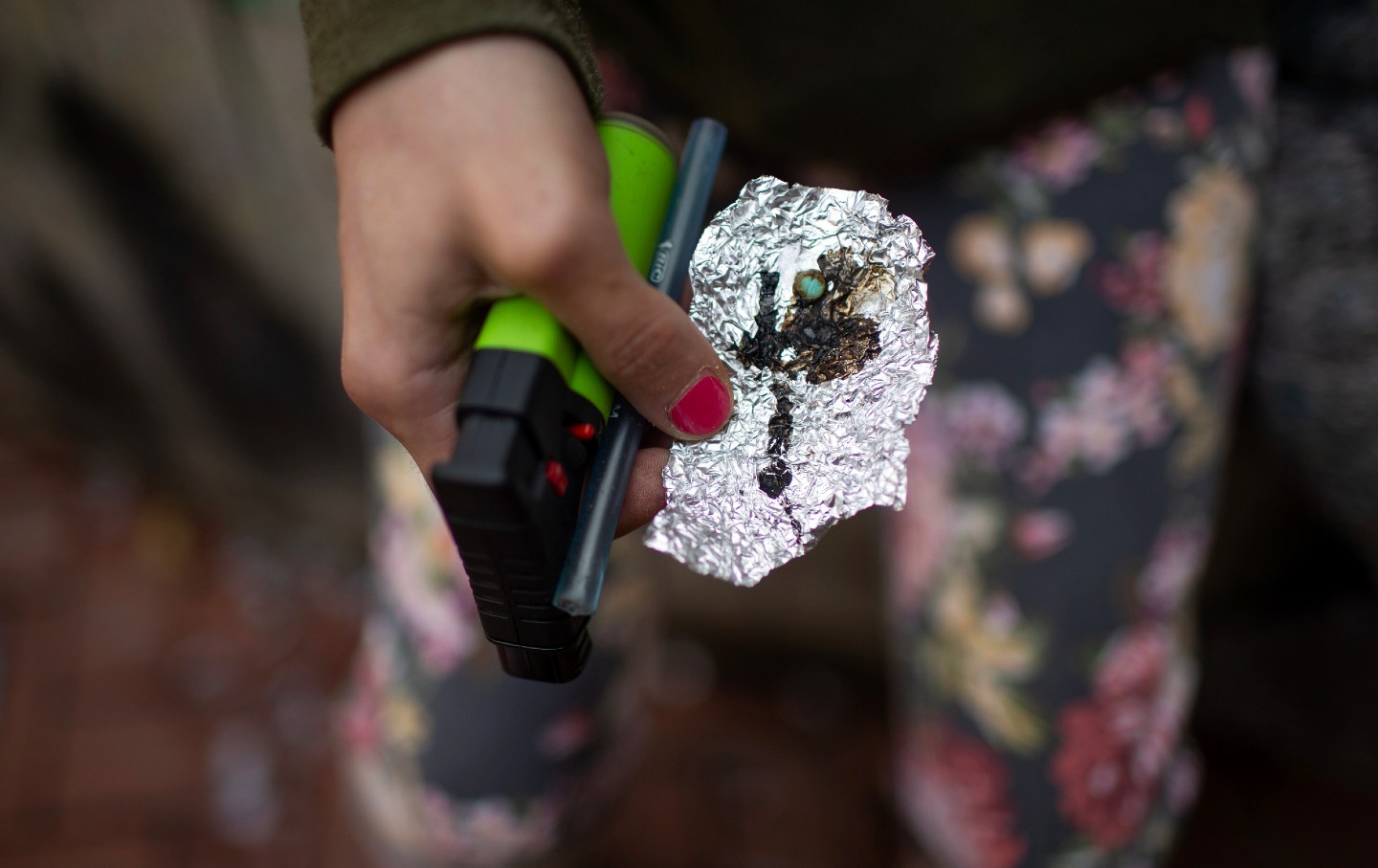 A person holds drug paraphernalia near the Washington Center building on SW Washington St. in downtown Portland, Ore., on April 4, 2023.