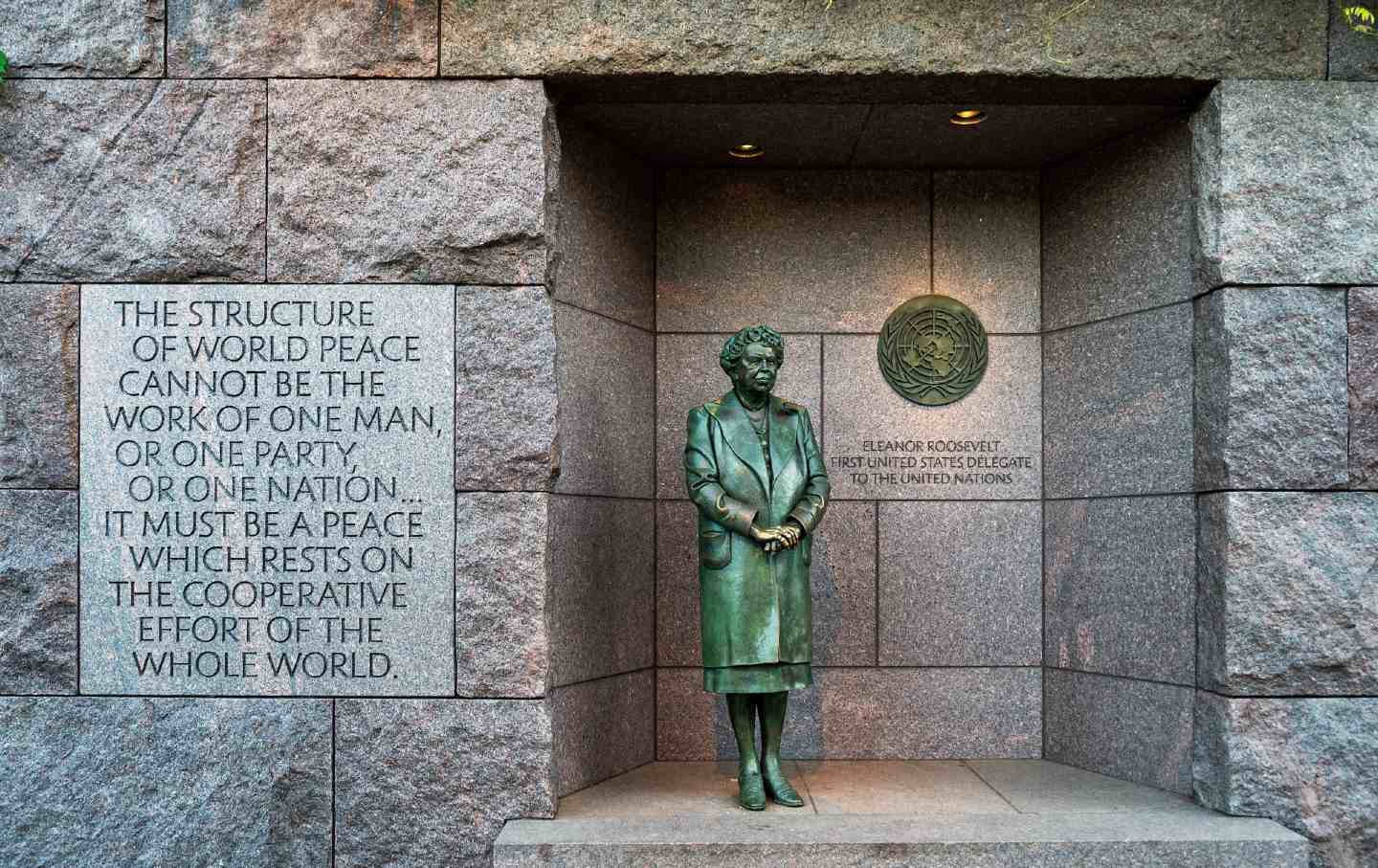 The statue of first lady Eleanor Roosevelt stands before the United Nations emblem at the Franklin Delano Roosevelt memorial.