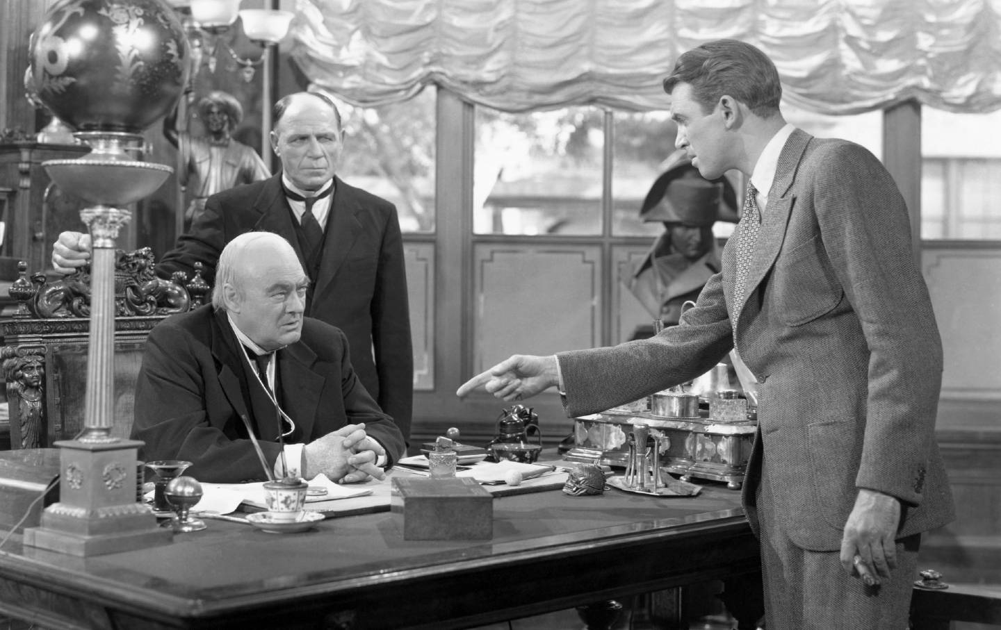 James Stewart, as George Bailey, points at Lionel Barrymore in a scene from “It's a Wonderful Life.”
