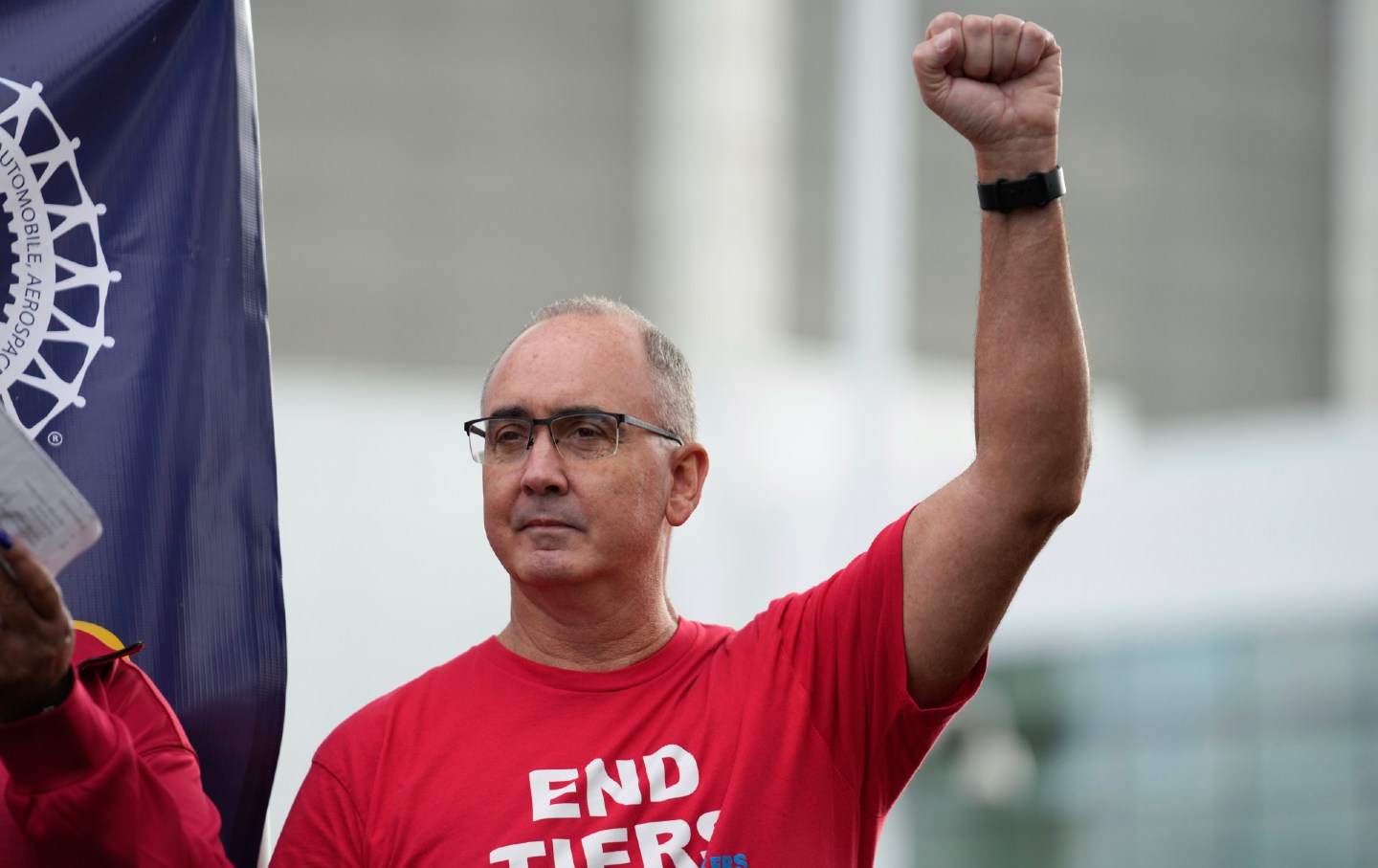 United Auto Workers President Shawn Fain raises his fist at a rally in Detroit on September 15, 2023.