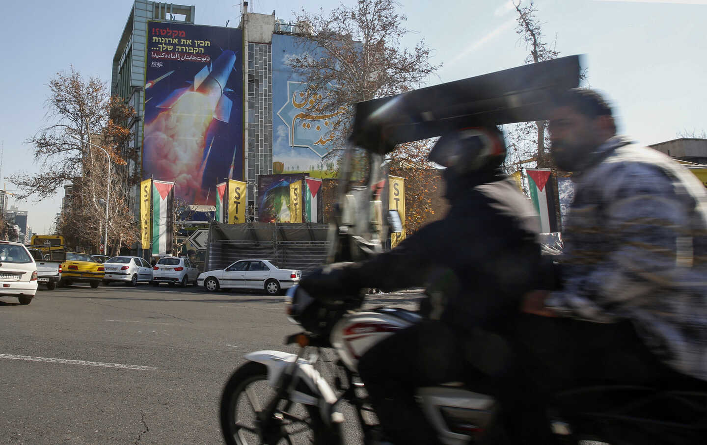 A large billboard depicting an Iranian missile with a phrase in Persian which reads “prepare your coffins\” hangs on the side of a building in Tehran on January 16, 2024, after Iran's overnight missile attacks on multiple targets in Syria and in Iraq's autonomous Kurdistan region.