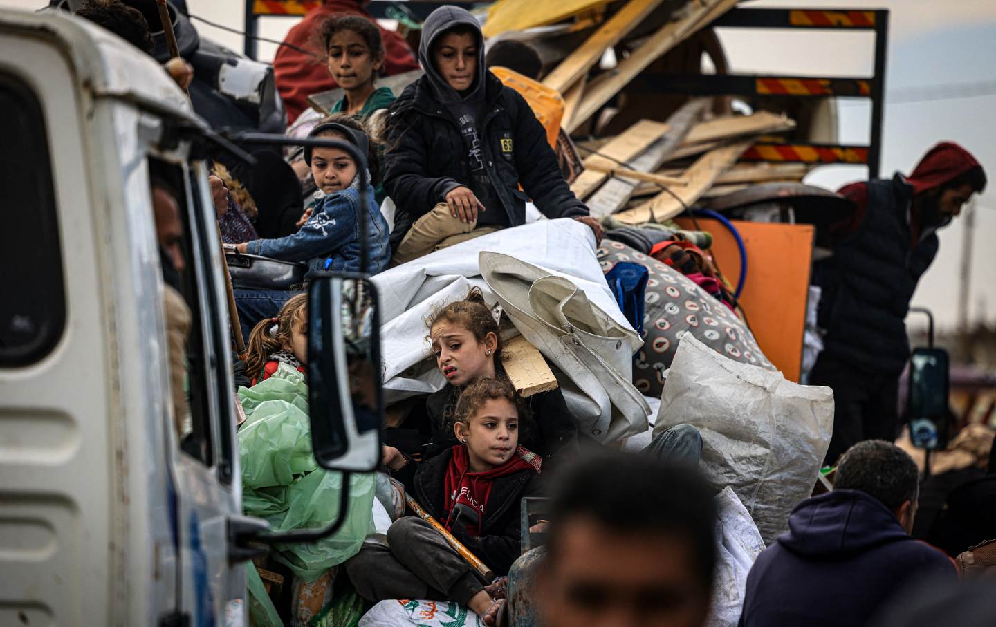 Palestinians carry some belongings as they flee Khan Yunis in the southern Gaza Strip on January 26, 2024