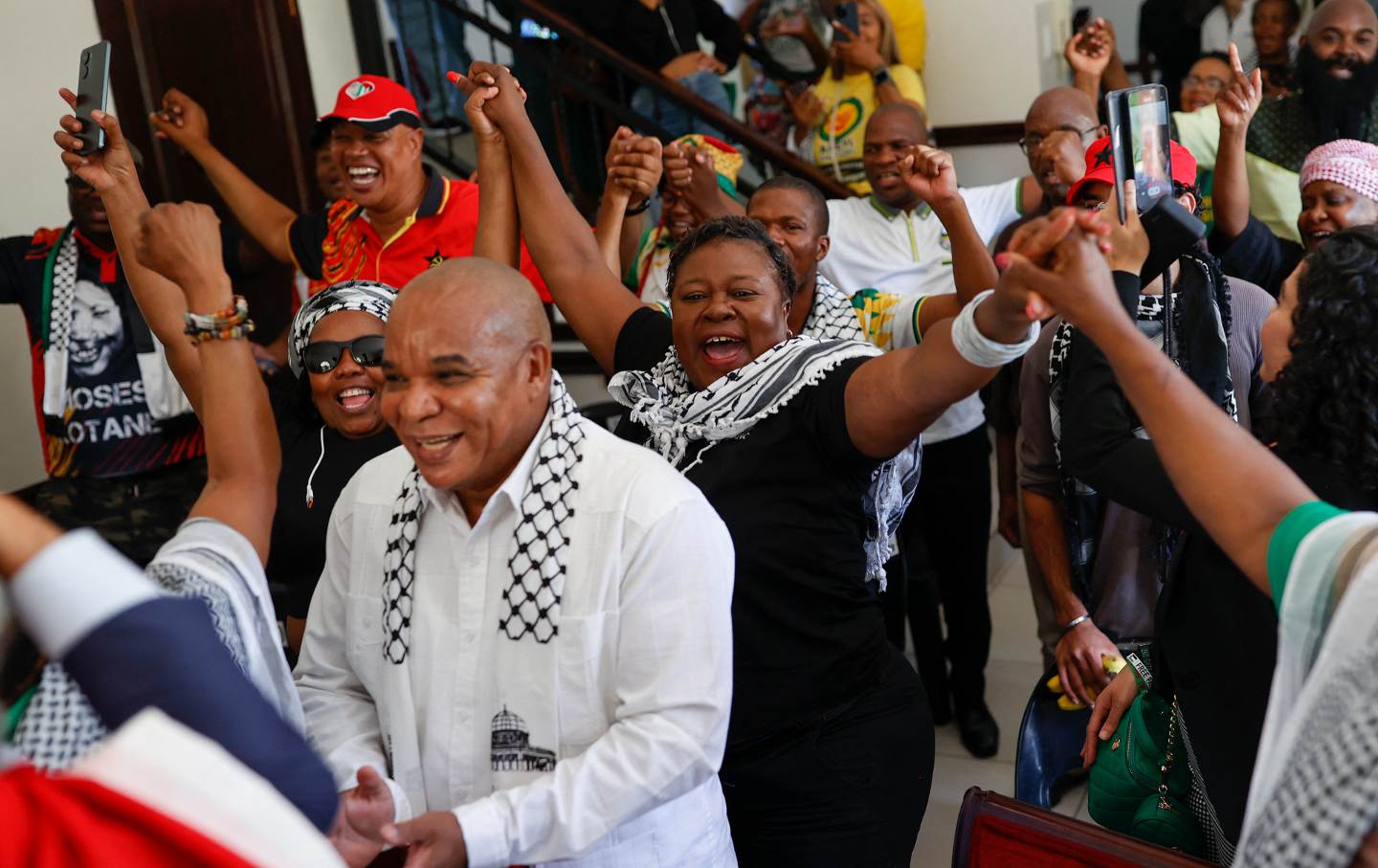 Pro-Palestinian supporters react in celebration after watching the International Court of Justice (ICJ) delivering its decision following a hearing of the case against Israel brought by South Africa in The Hague at the Embassy of Palestine in Pretoria on January 26, 2024.