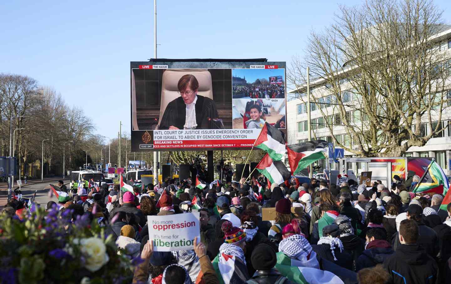 Pro-Palestinian supporters watch proceedings outside the International Court of Justice during the court ruling in The Hague, Netherlands, on Friday, Jan. 26, 2024.