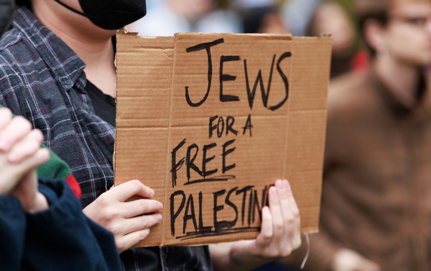 A protester holds a placard reading, “Jews for a Free Palestine,” in Dunn Meadow at Indiana University to demonstrate against the Israeli ground operation into Gaza. The rally was titled, “Stand With Gaza. Rally and Mourn the Innocent Lives of Palestinians.”