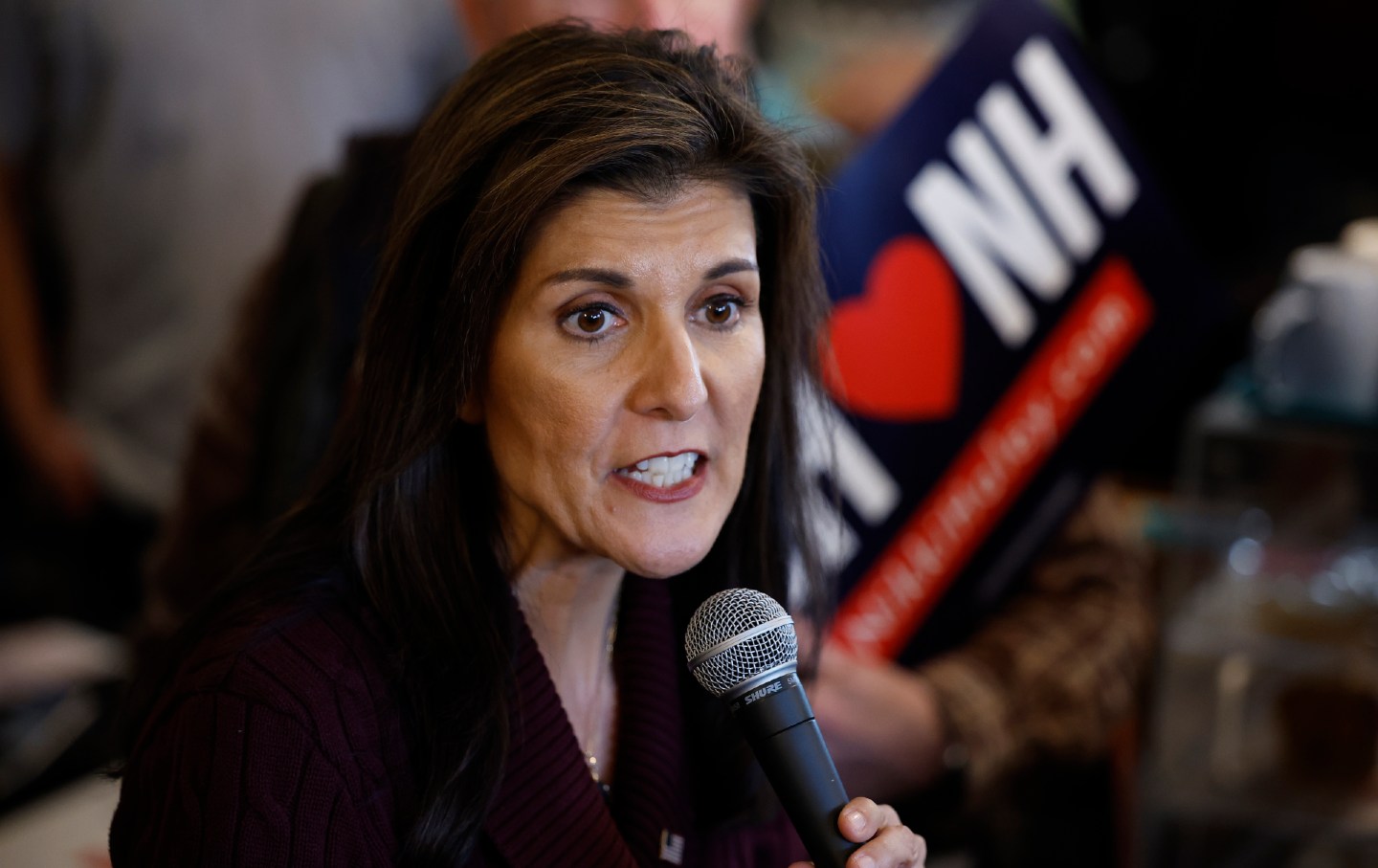Nikki Haley talks to a group of people while campaigning in New Hampshire.