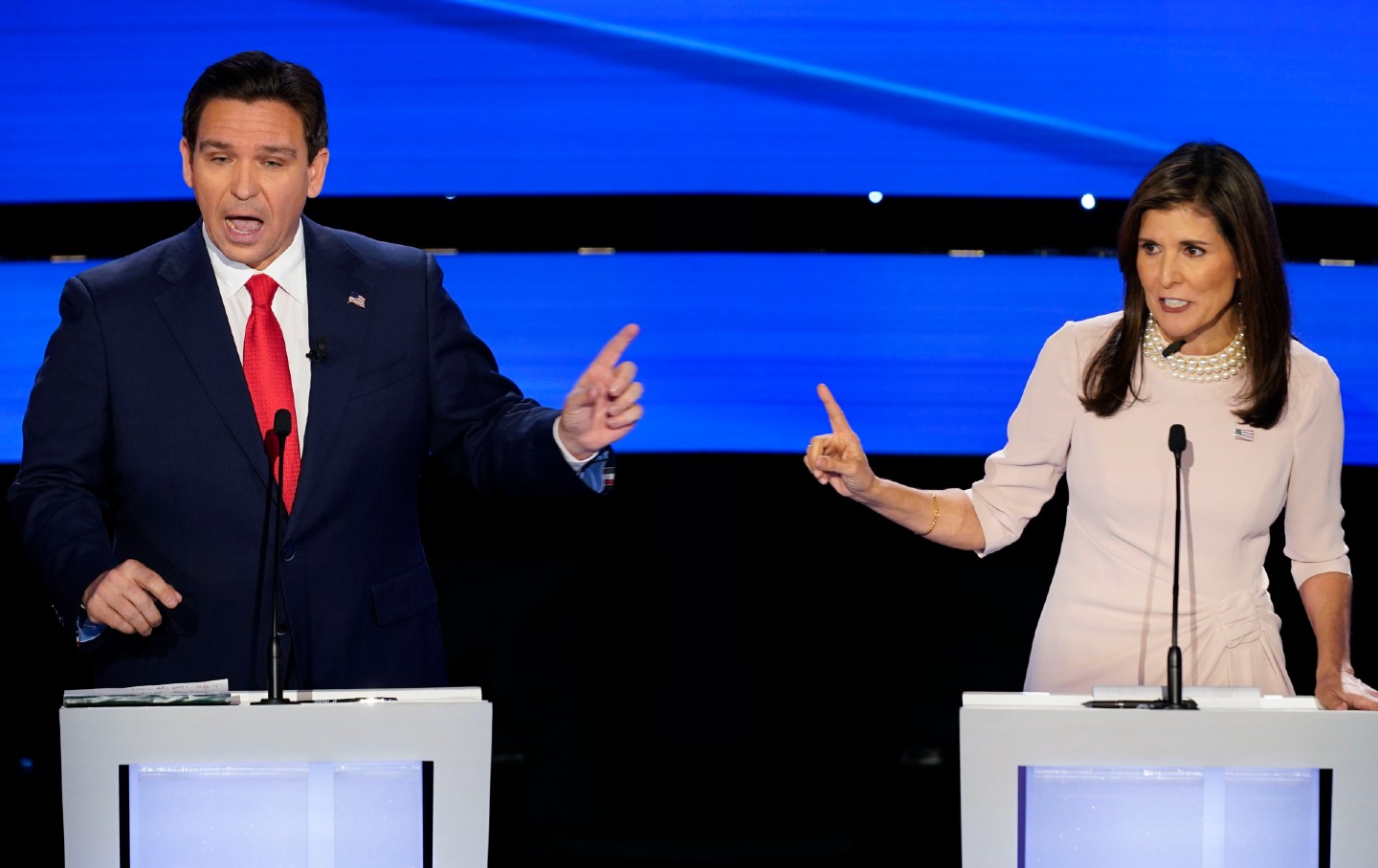 Former UN ambassador Nikki Haley, right, and Florida Governor Ron DeSantis, left, speak at the same time at the CNN Republican presidential debate in Des Moines, Iowa, on January 10, 2024.