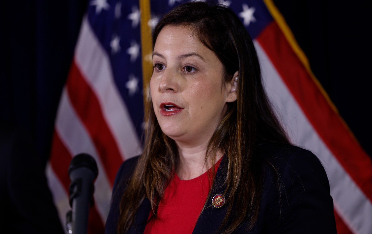 Rep. Elise Stefanik speaking in front of an American flag.