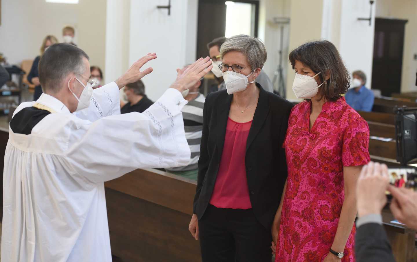 A priest blesses a lesbian couple in Munich.