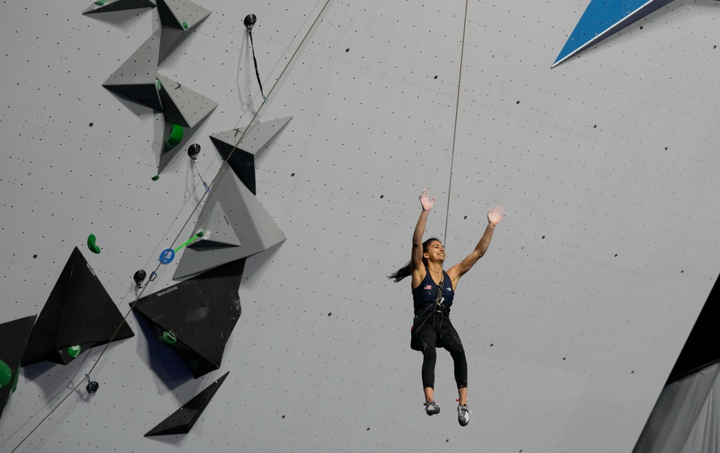 Natalia Grossman of the United States raises her arms after winning gold in the women's boulder lead climbing final at the Pan American Games in Santiago, Chile, Tuesday, Oct. 24, 2023.