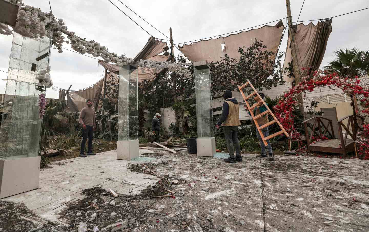 Palestinians inspect a damaged wedding Photography studio following Israeli strikes in Gaza City on February 13, 2023.