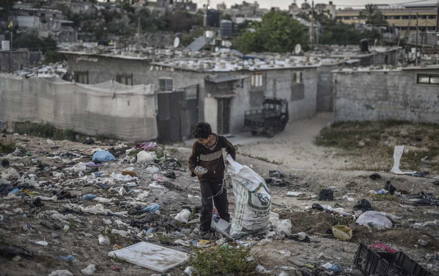 A 12 year-old, Palestinian boy named Hasan Abu Emune collects recyclable material such as, paper, metal and glass to contribute his family's livelihood as the daily life continues under difficult conditions in Khan Yunis, Gaza on April 24, 2023.