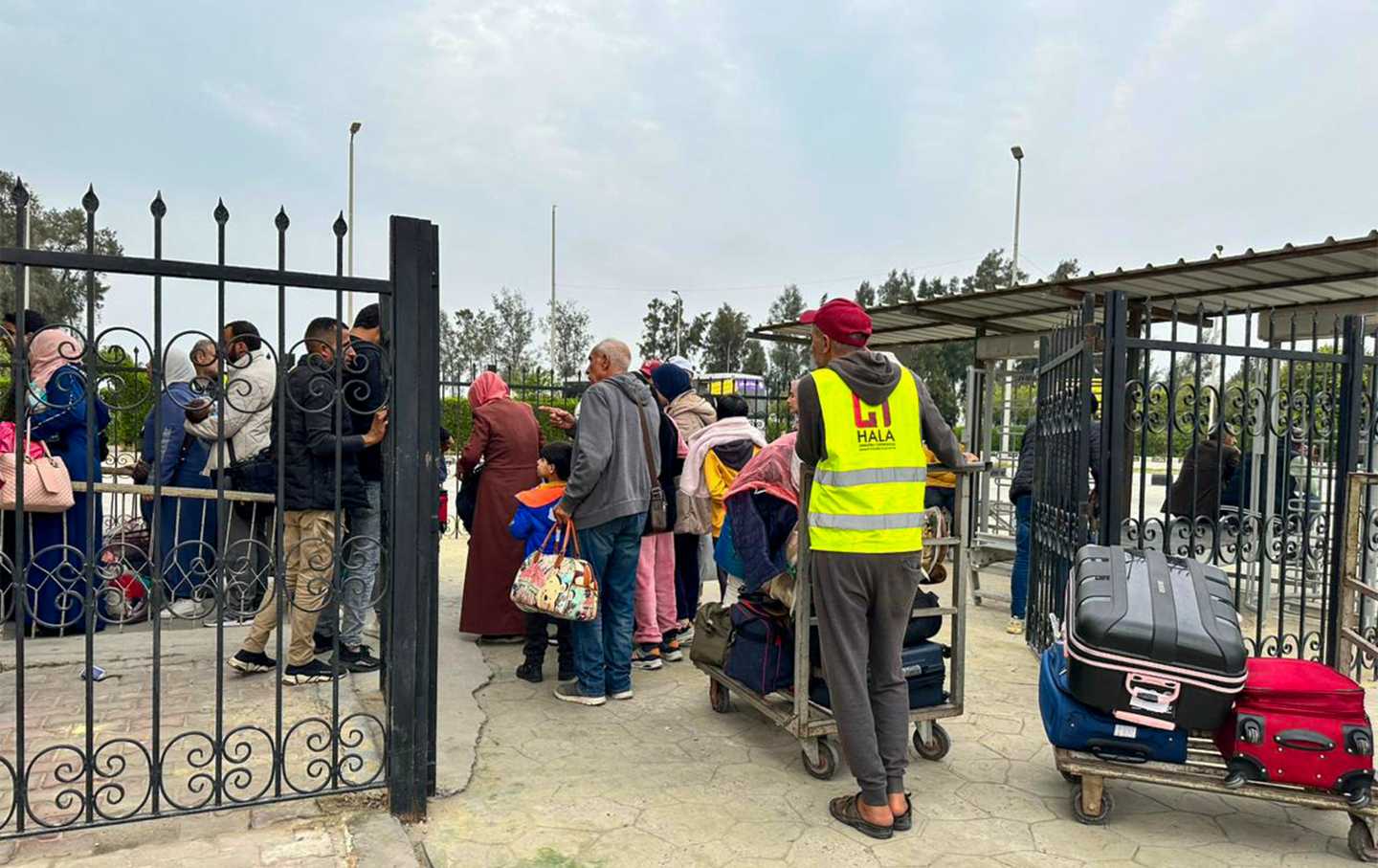 Palestinians and dual nationality holders fleeing from Gaza arrive on the Egyptian side of the Rafah border crossing with the Gaza Strip on December 5, 2023
