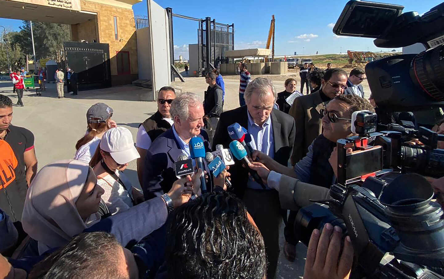 US Senators Chris Van Hollen (C-L) and Jeff Merkley (C-R) talk to the press as they visit the Egyptian side of the Rafah border crossing with the southern Gaza Strip along with a US delegation on January 5, 2024.