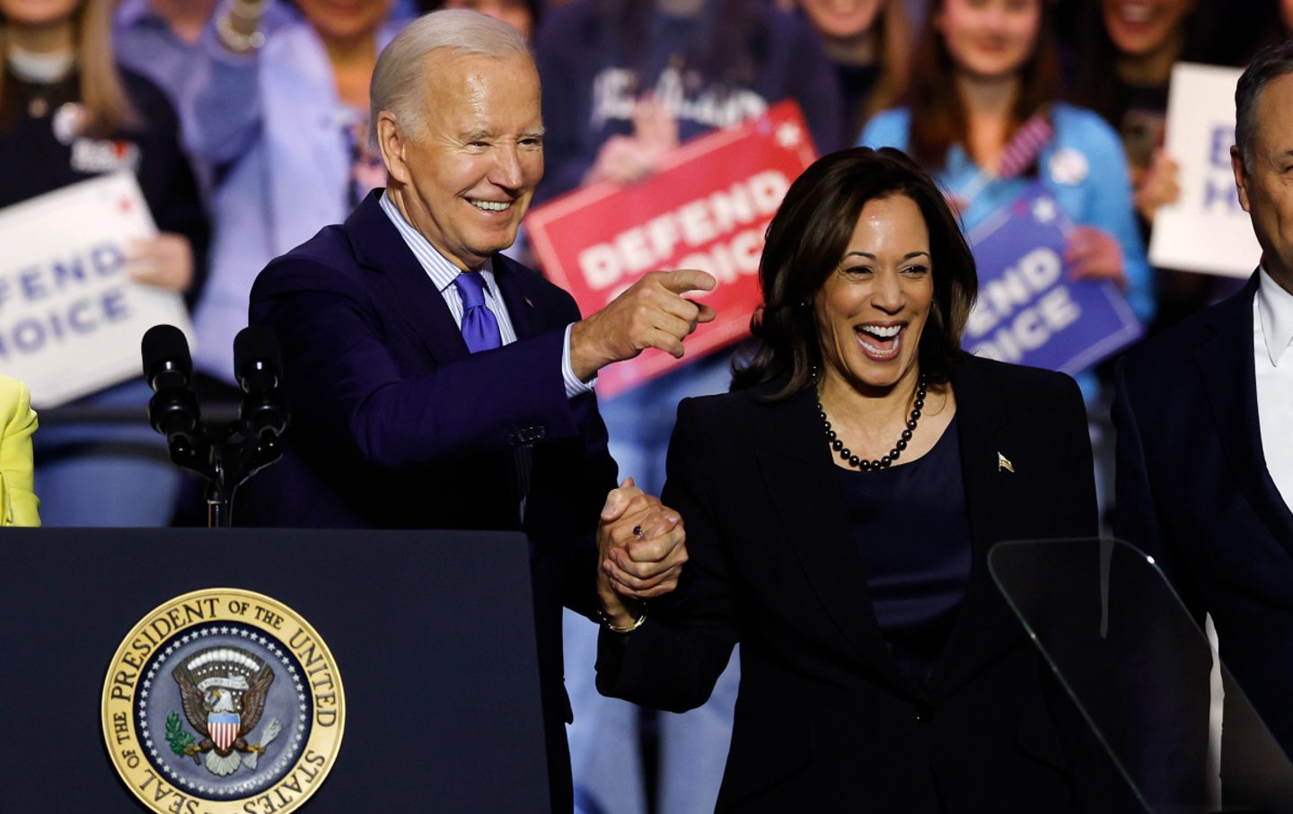 President Joe Biden and Vice President Kamala Harris join hands as they depart a “Reproductive Freedom Campaign Rally” at George Mason University on January 23, 2024, in Manassas, Va.