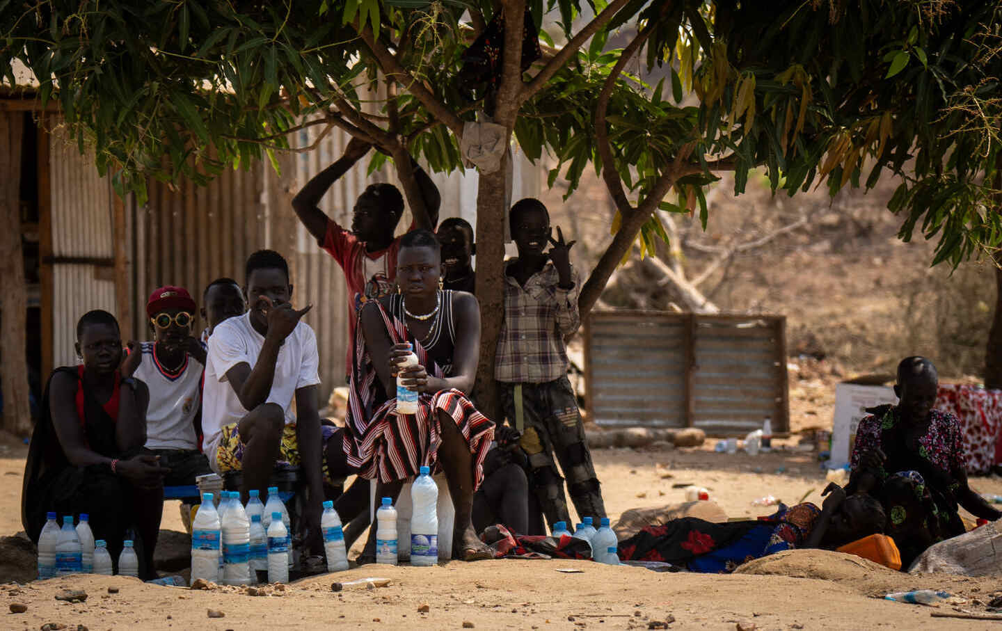 Young men sell milk along the street in Juba.