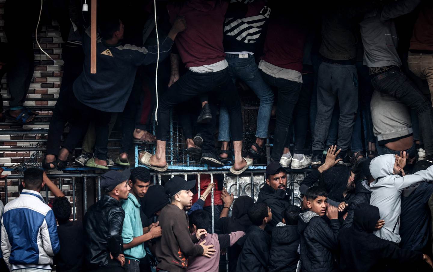 Palestinians crowd oustide a bakery to buy bread in Rafah